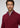 A man with short curly hair and a beard wears the Milano 1/4 Zip Merino Wool Sweater in burgundy over a blue checkered shirt, exemplifying luxury men’s knitwear, while looking directly at the camera against a neutral background.