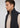 A man with short brown hair wears a beige half-zip pullover layered under the Stelvio Padded Vest in black, facing left against a plain light background. This look blends business casual style with lightweight warmth for versatile comfort.