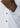 Close-up of a hand and wrist wearing the white Bergamo Stretch Button Down, featuring a blue patterned inner cuff. Two buttons are visible on this four-way stretch shirt.