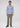 A man stands facing forward, wearing the Hennepin Button Down—a tailored fit cotton business casual shirt in light blue plaid—paired with khaki pants and dark brown shoes, against a plain white background.