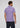 A man stands facing away, wearing the short-sleeved Lyon Reversible Polo in light purple paired with dark jeans, set against a plain light background—a men’s everyday essential crafted for both style and versatility.