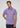 A man stands against a plain background, wearing the Lyon Reversible Polo—a short-sleeve, light purple patterned UPF 50+ shirt—and dark jeans, making for an ideal men’s everyday essential. He looks directly at the camera with a neutral expression.