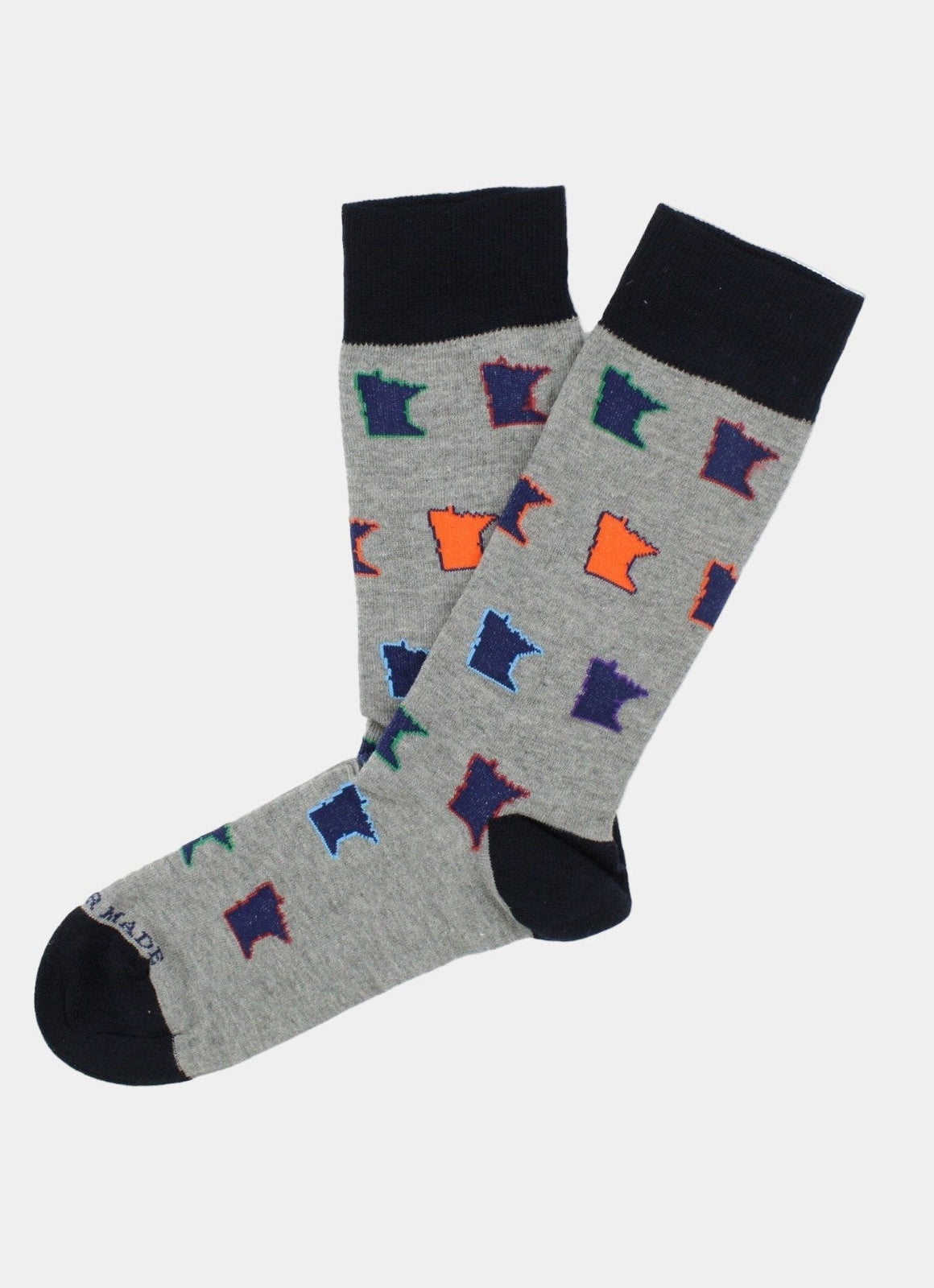 The Multi MN Pop Sock features gray fabric with black cuffs, heels, and toes, and is adorned with a vibrant repeating pattern of Minnesota state outlines in blue, purple, green, orange, and red. Made in Turkey for comfortable everyday wear and fits sizes 8-12.