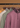 Four Onamia Reversible 1/4 Zip pullovers, including a beige option ideal for men’s layering, hang on wooden hangers from a black clothing rack against a brown background.