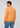 A man wearing the Onamia Reversible 1/4 Zip pullover in light orange and blue jeans stands facing away, looking over his left shoulder, against a plain light background.
