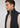 A man with short brown hair wears a beige half-zip pullover layered under the Stelvio Padded Vest in black, facing left against a plain light background. This look blends business casual style with lightweight warmth for versatile comfort.