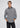 A man wearing a grey Superior Stretch Flannel button-down shirt with two chest pockets, layered over a dark quarter-zip sweater.