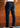 Wearing the Tailored Fit Denim, which offers stretch comfort in a dark blue wash, a person paired with white sneakers stands with their back to the camera in front of a wooden wall.